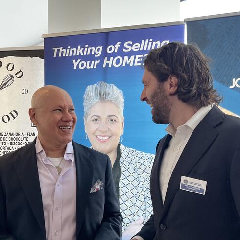 Jon Greenfield, YU’s Assistant Vice President for Government Relations and Vice President of the Washington Heights Chamber of Commerce, greets an event attendee.